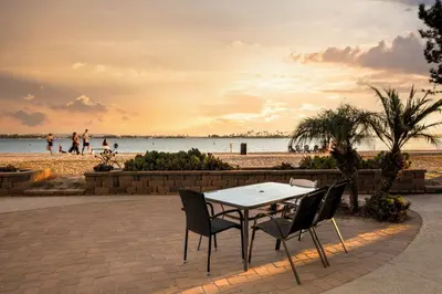 a table and chairs in front of a beach at Bayfront Bliss in San Diego
