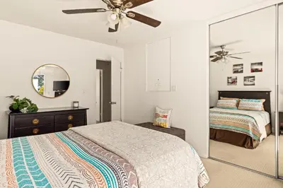 a bedroom with a bed and a mirror at Bayfront Bliss in San Diego
