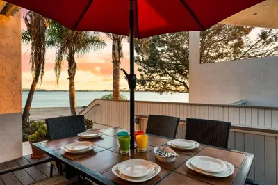 a table with plates and drinks and an umbrella at Bayfront Bliss in San Diego