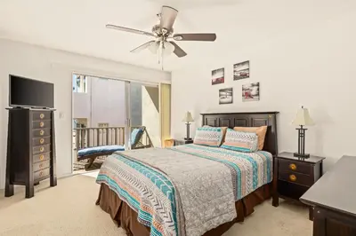 a bedroom with a bed and a ceiling fan at Bayfront Bliss in San Diego