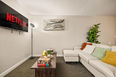 a living room with a white couch and a table at Luxury 2BR Apartment Near SeaWorld, Airport & Downtown San Diego in San Diego