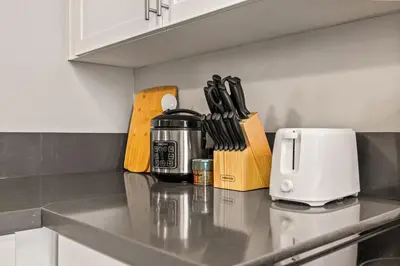a kitchen counter with a coffee pot and knives at Luxury 2BR Apartment Near SeaWorld, Airport & Downtown San Diego in San Diego