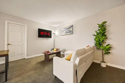 a living room with a white couch and a table at Luxury 2BR Apartment Near SeaWorld, Airport & Downtown San Diego in San Diego