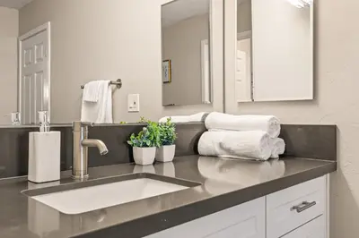 a bathroom with a sink and a large mirror at Luxury 2BR Apartment Near SeaWorld, Airport & Downtown San Diego in San Diego
