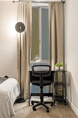a desk with a chair and a lamp in a bedroom at Luxury 2BR Apartment Near SeaWorld, Airport & Downtown San Diego in San Diego