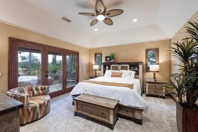 a bedroom with a bed and a ceiling fan at Tuscan Views with Country Vibes in Bonsall