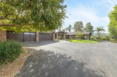 a house with a garage and a driveway at Tuscan Views with Country Vibes in Bonsall