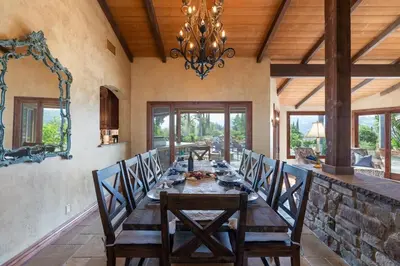 a dining room with a long table with chairs at Tuscan Views with Country Vibes in Bonsall