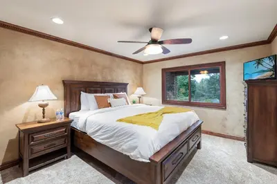 a bedroom with a large bed and a ceiling fan at Tuscan Views with Country Vibes in Bonsall