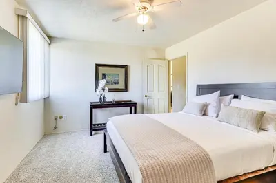 a bedroom with a large bed and a ceiling fan at Hike, Sip and Explore Couples Retreat in Fallbrook in Fallbrook