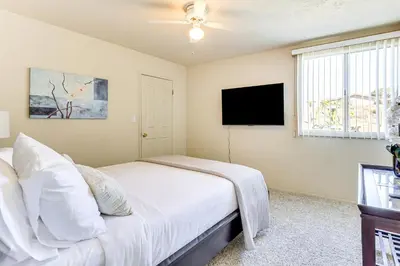 a bedroom with a bed and a flat screen tv at Hike, Sip and Explore Couples Retreat in Fallbrook in Fallbrook