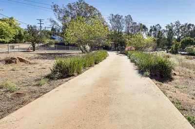 a dirt path in a field with trees at Hike, Sip and Explore Couples Retreat in Fallbrook in Fallbrook