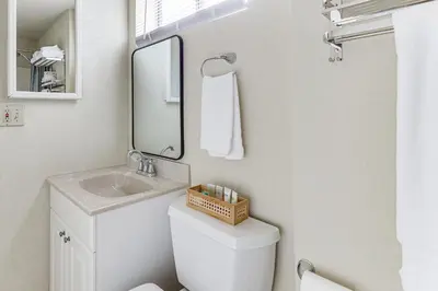 a bathroom with a sink and a toilet and a mirror at Hike, Sip and Explore Couples Retreat in Fallbrook in Fallbrook