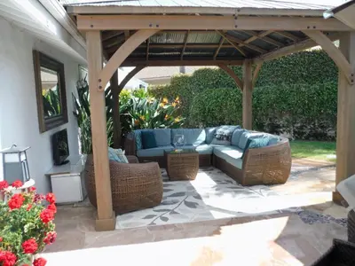 a pergola with a couch and chairs on a patio at Bella Vita Gated Resort in Escondido