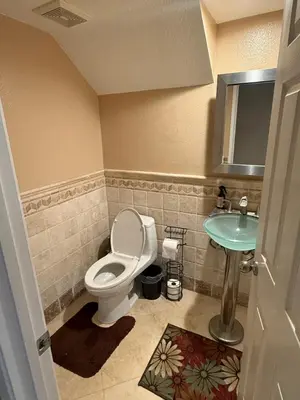 a bathroom with a toilet and a sink at South OC House in Laguna Niguel
