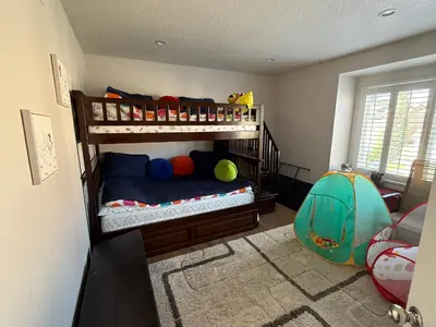 a childs bedroom with bunk beds and a tent at South OC House in Laguna Niguel