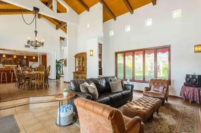 a living room with a leather couch and a table at Fallbrook Vineyard Estate in Fallbrook