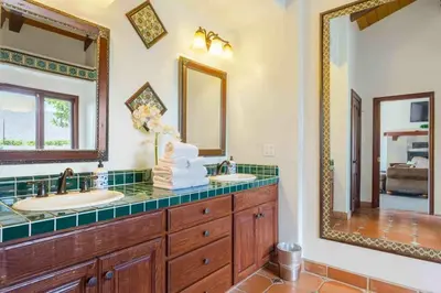 a bathroom with two sinks and a large mirror at Fallbrook Vineyard Estate in Fallbrook