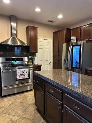 a kitchen with a stainless steel stove and refrigerator at Oasis in Southern California for 8 guests in Winchester