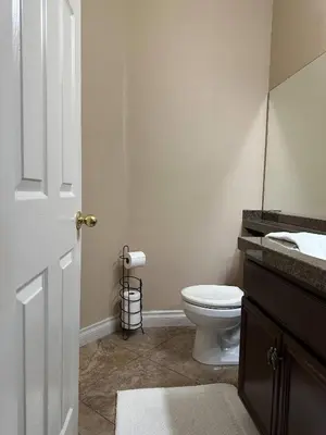 a bathroom with a white toilet and a sink at Oasis in Southern California for 8 guests in Winchester