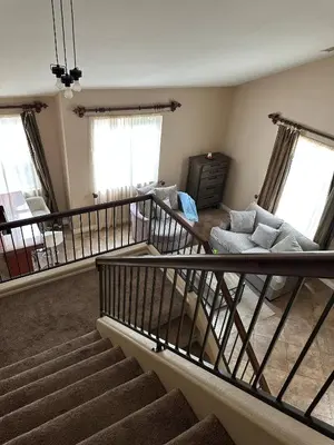 an empty living room with stairs and a couch at Oasis in Southern California for 8 guests in Winchester