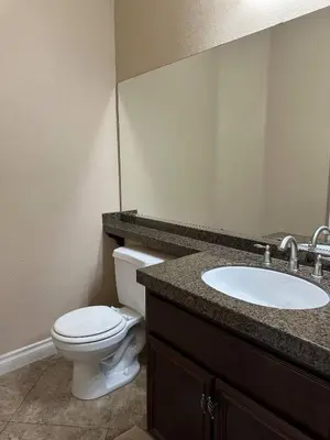 a bathroom with a white toilet and a sink at Oasis in Southern California for 8 guests in Winchester