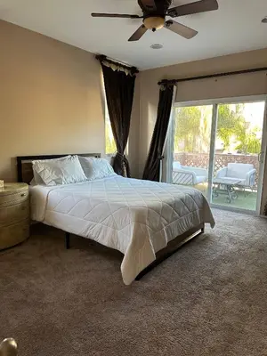 a bedroom with a bed and a ceiling fan at Oasis in Southern California for 8 guests in Winchester