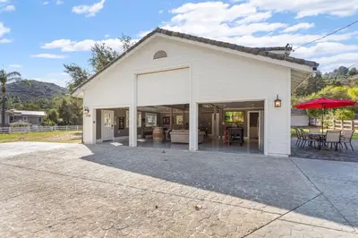 a white barn with a patio and a table at Man Cave and She Shed in Fallbrook