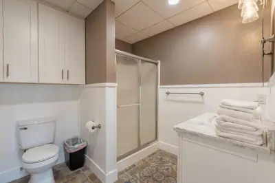 a bathroom with a toilet and a shower with towels at Man Cave and She Shed in Fallbrook