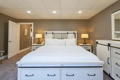 a bedroom with a white bed and two lamps at Man Cave and She Shed in Fallbrook