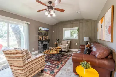 a living room with leather furniture and a fireplace at Man Cave and She Shed in Fallbrook