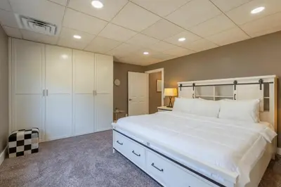 a large bedroom with a large white bed and cabinets at Man Cave and She Shed in Fallbrook
