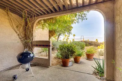 an outdoor patio with a grill and potted plants at Pool and Tennis Court Access Borrego Springs Condo in Borrego Springs