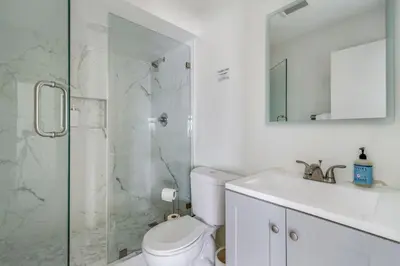a bathroom with a shower and a toilet and a sink at VaCaTiOn Pool FirePit PoolTable CloseToFwy in Mission Viejo