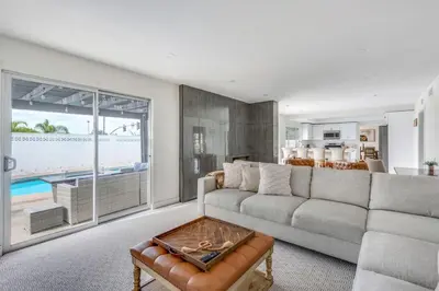 a living room with a couch and a table at VaCaTiOn Pool FirePit PoolTable CloseToFwy in Mission Viejo