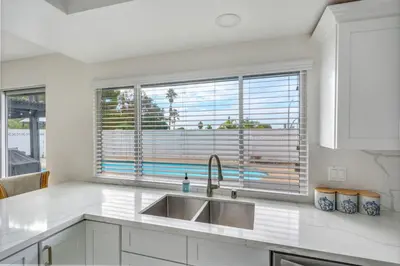 a kitchen with a sink and a large window at VaCaTiOn Pool FirePit PoolTable CloseToFwy in Mission Viejo