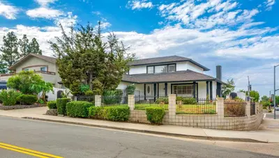 a house on a street with a fence at VaCaTiOn Pool FirePit PoolTable CloseToFwy in Mission Viejo