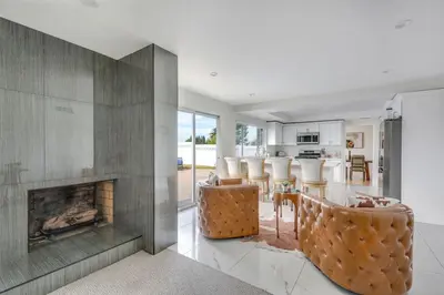 a kitchen and living room with a fireplace at VaCaTiOn Pool FirePit PoolTable CloseToFwy in Mission Viejo