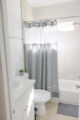 a bathroom with a white toilet and a shower curtain at Mira Mesa Private Suite with Private Bath & Entry #1 in San Diego