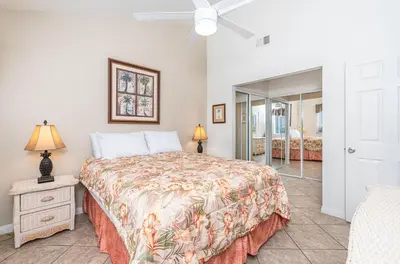 a bedroom with a bed and a ceiling fan at Charming 6Br Retreat With Oceanview Patio, Steps From Sand By Beachview Rentals in Newport Beach