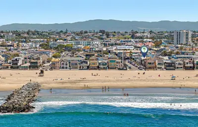 a view of a beach with people in the water at Charming 6Br Retreat With Oceanview Patio, Steps From Sand By Beachview Rentals in Newport Beach
