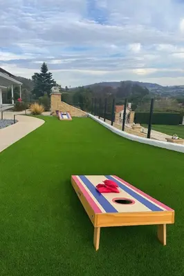 a bed on top of a field of green grass at Luxury Oasis Valley Views Gameroom Villa in Vista