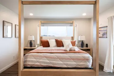 a bed with a wooden frame in a bedroom at Luxury Oasis Valley Views Gameroom Villa in Vista