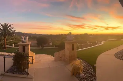 a view of a sunset from the balcony of a house at Luxury Oasis Valley Views Gameroom Villa in Vista