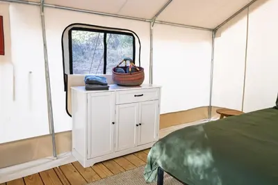 a room with a bed and a window in a tent at Boutique Nature Retreat in the Palomar Mountains in Pauma Valley