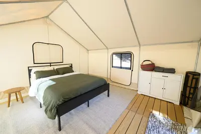 a bedroom with a bed in a tent at Peaceful Mountain Tent Escape at Harrison Ranch in Pauma Valley
