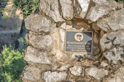 a plaque on the side of a stone wall at Peaceful Mountain Tent Escape at Harrison Ranch in Pauma Valley