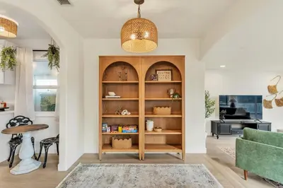 a living room with a wooden book shelf at Newly Furnished 3BR 1BA - Spa - AC - Large Backyard in San Diego