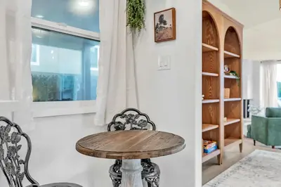 a wooden table and chairs in a living room at Newly Furnished 3BR 1BA - Spa - AC - Large Backyard in San Diego