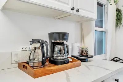 a kitchen counter with a blender on a cutting board at Newly Furnished 3BR 1BA - Spa - AC - Large Backyard in San Diego